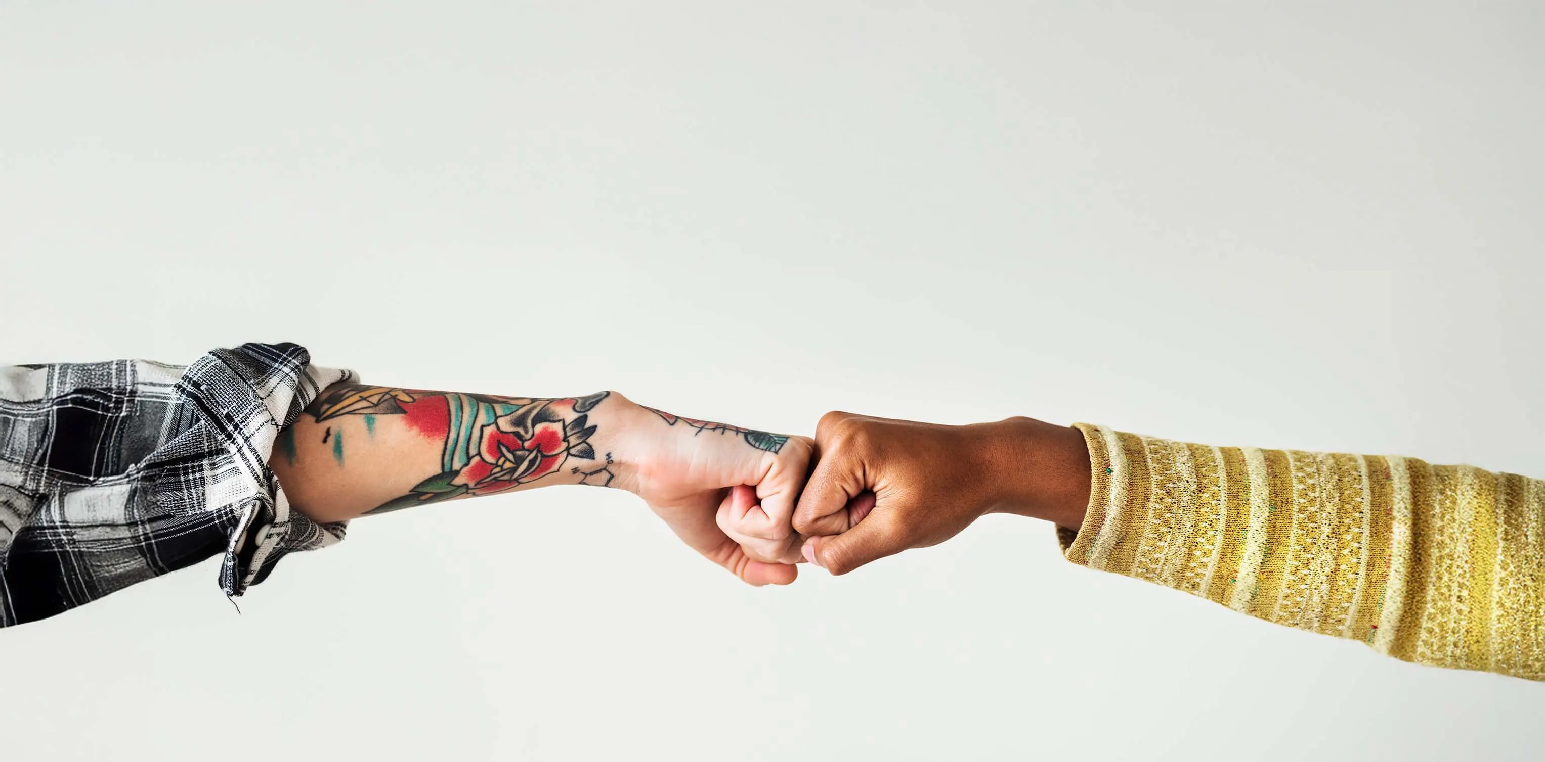 Two arms fist bumping representing connection and unity for Stem Cell Donors Australia's Strength2Give campaign