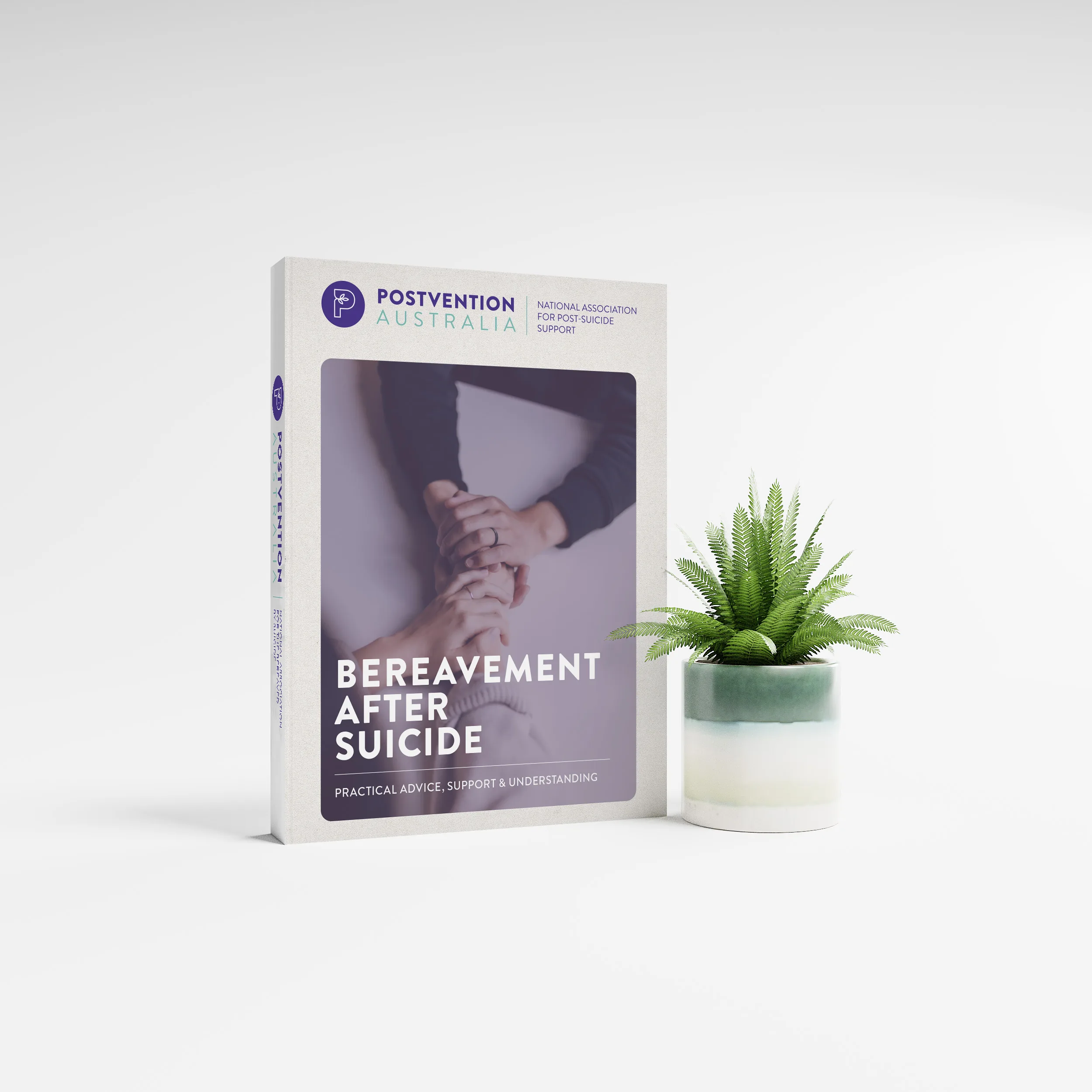 "Bereavement After Suicide," featuring specific branding and a cover photo of holding hands, displayed next to a small potted plant.