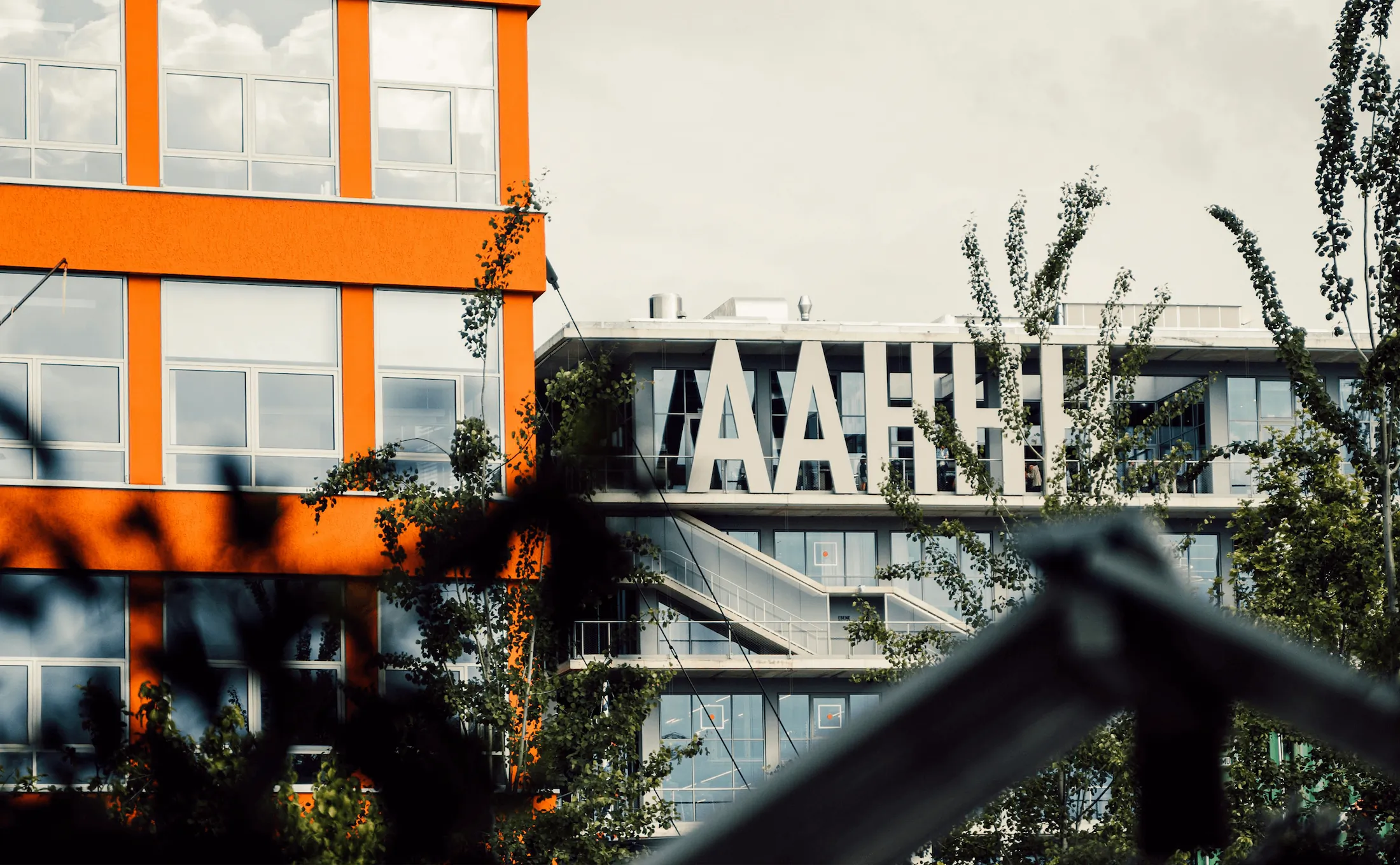 Contemporary urban office architecture with striking orange accents, featured on a Sydney marketing agency blog